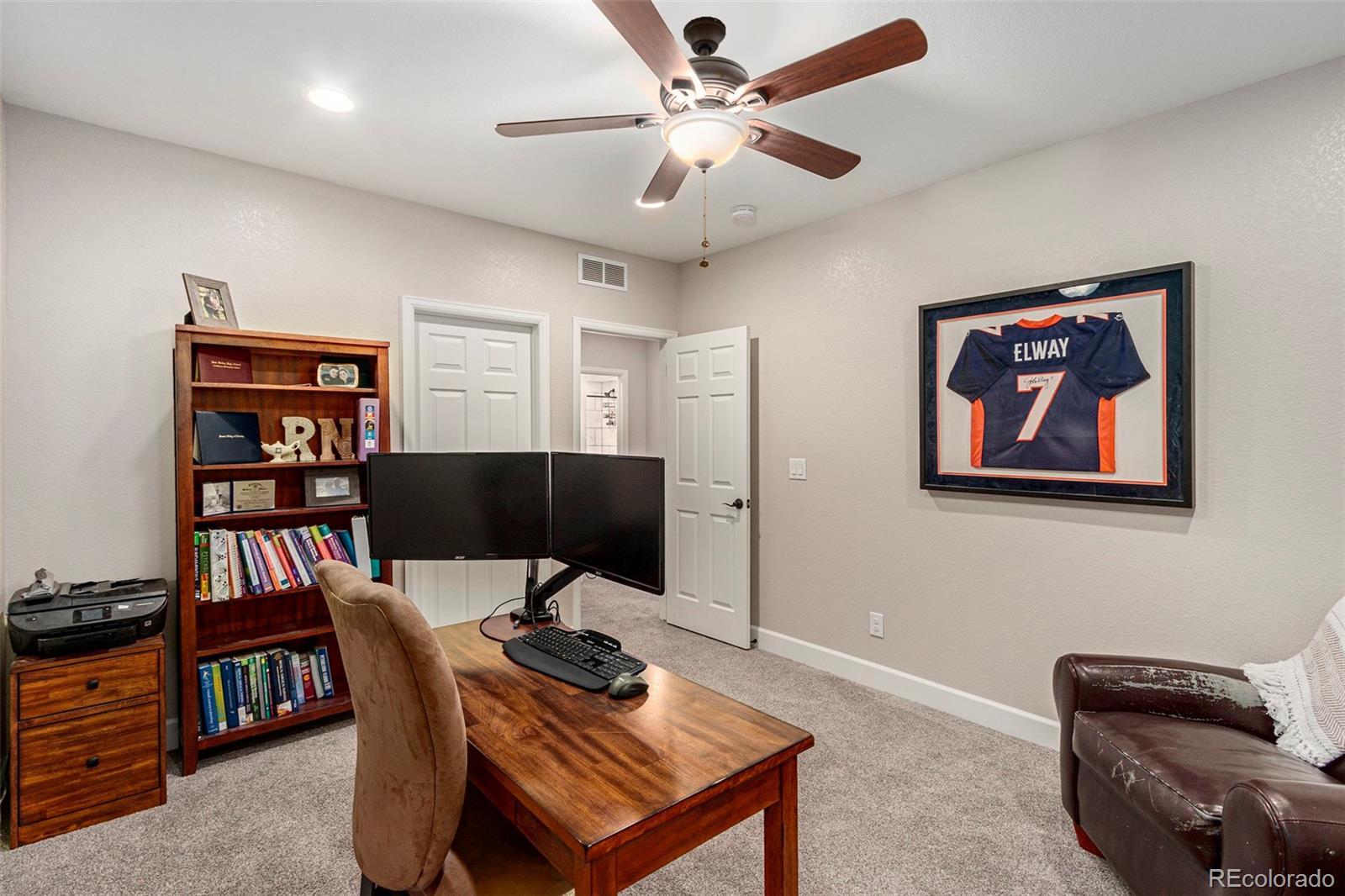 8875 Flattop Way Arvada, CO 80007 - Photo 23 of 38 a view of a workspace with furniture and a bookshelf