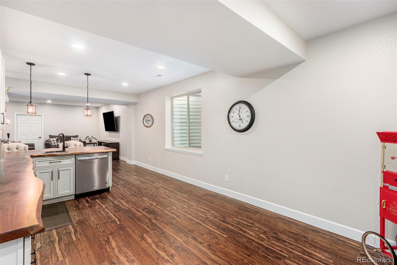 8875 Flattop Way Arvada, CO 80007 - Photo 28 of 38 a kitchen with a refrigerator and countertop white cabinets with wooden floor