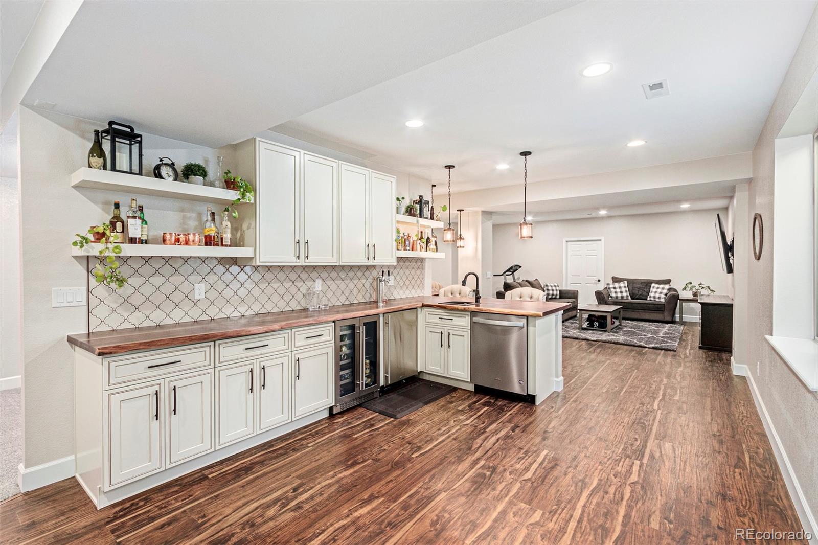 8875 Flattop Way Arvada, CO 80007 - Photo 29 of 38 a kitchen with a sink wooden floor and white stainless steel appliances