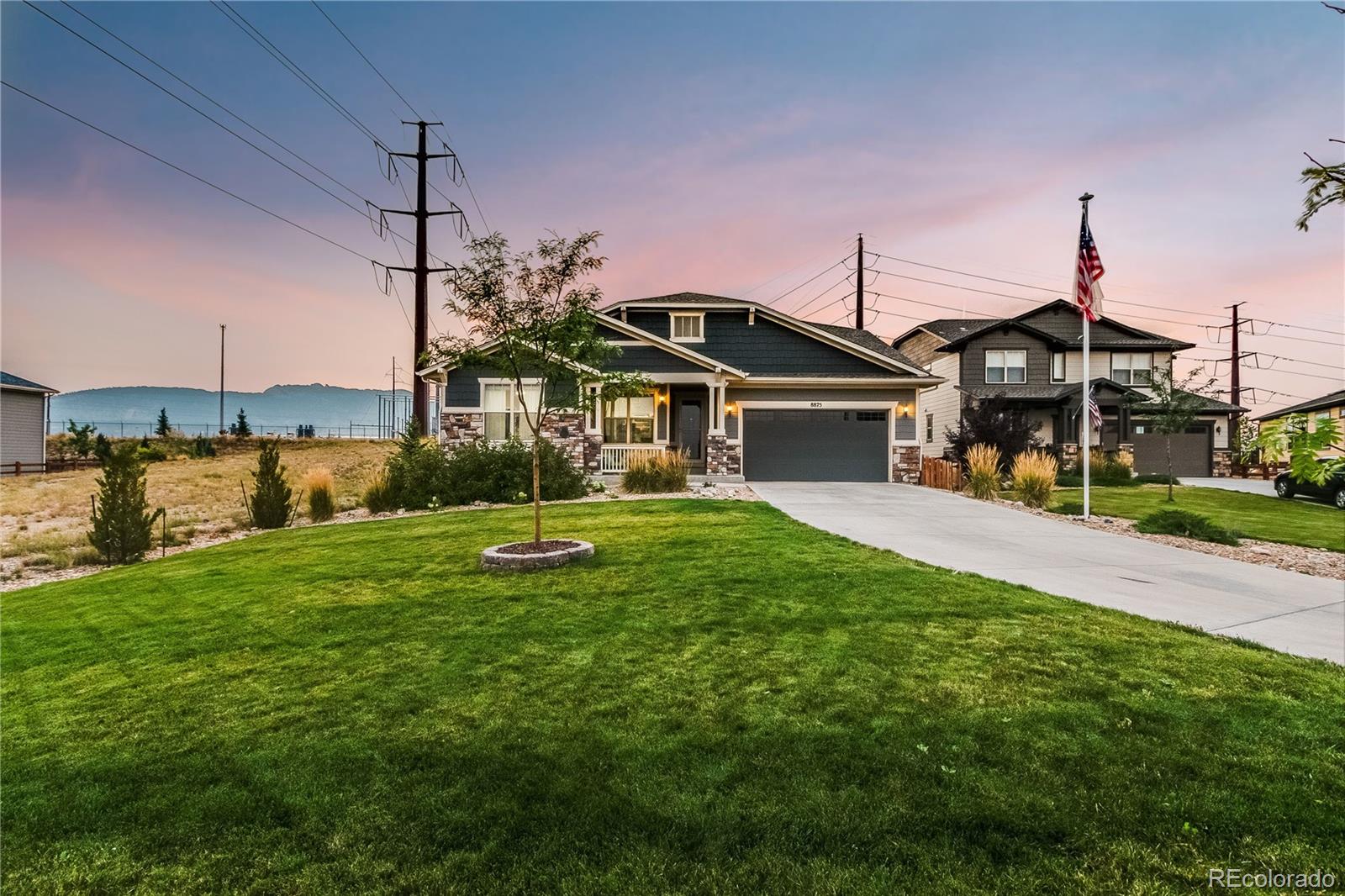 8875 Flattop Way Arvada, CO 80007 - Photo 3 of 38 a front view of a house with a yard
