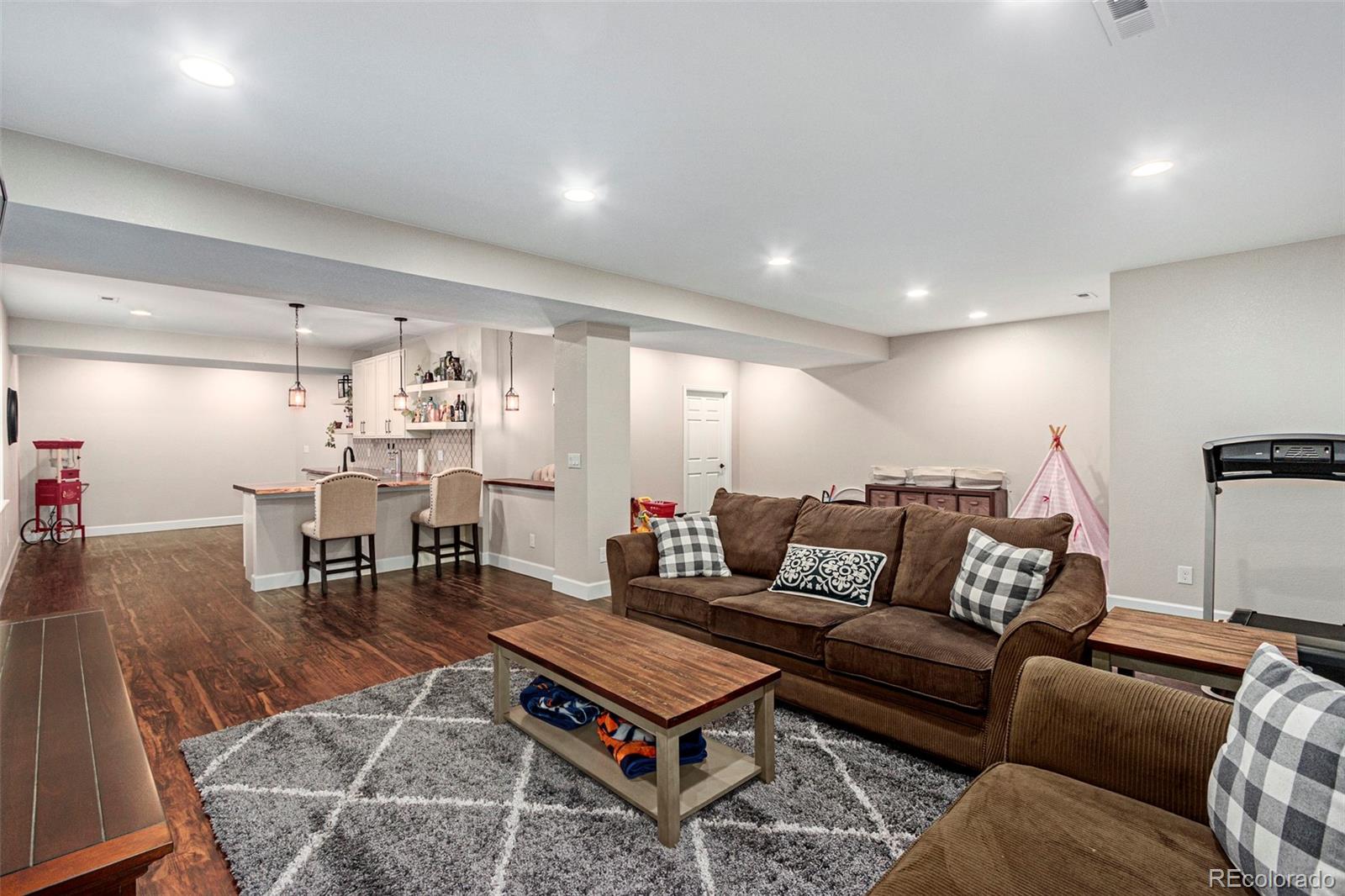 8875 Flattop Way Arvada, CO 80007 - Photo 31 of 38 a living room with furniture a wooden floor and a table