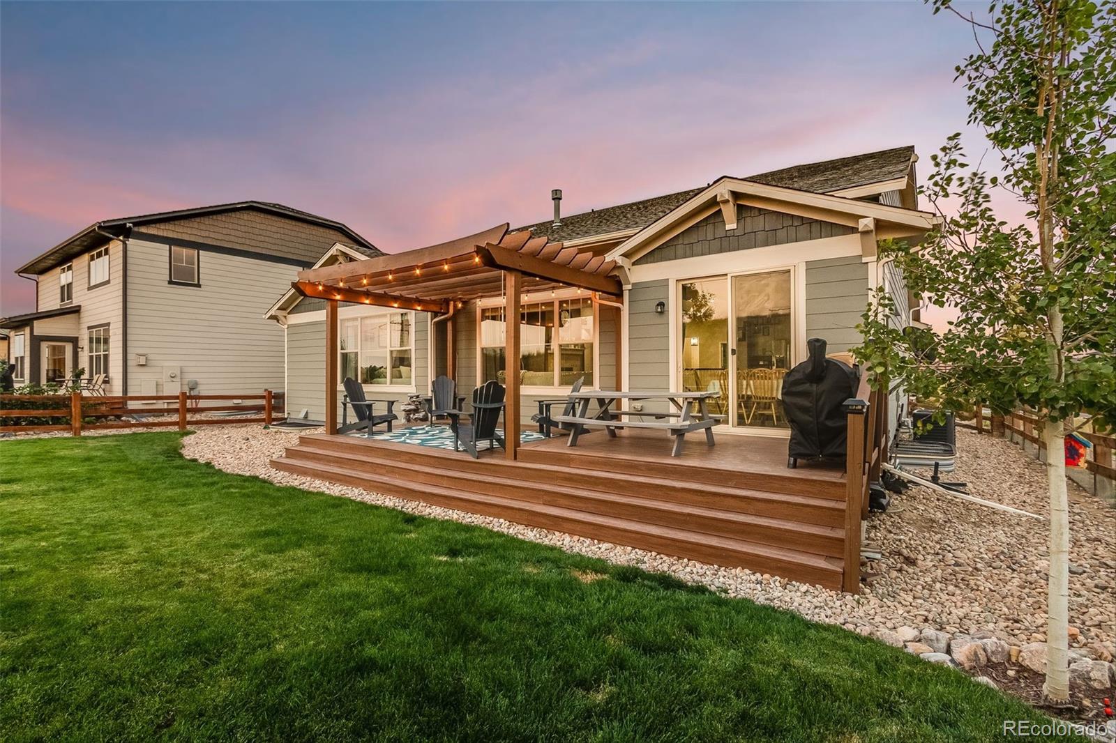 8875 Flattop Way Arvada, CO 80007 - Photo 36 of 38 a front view of a house with a yard table and chairs