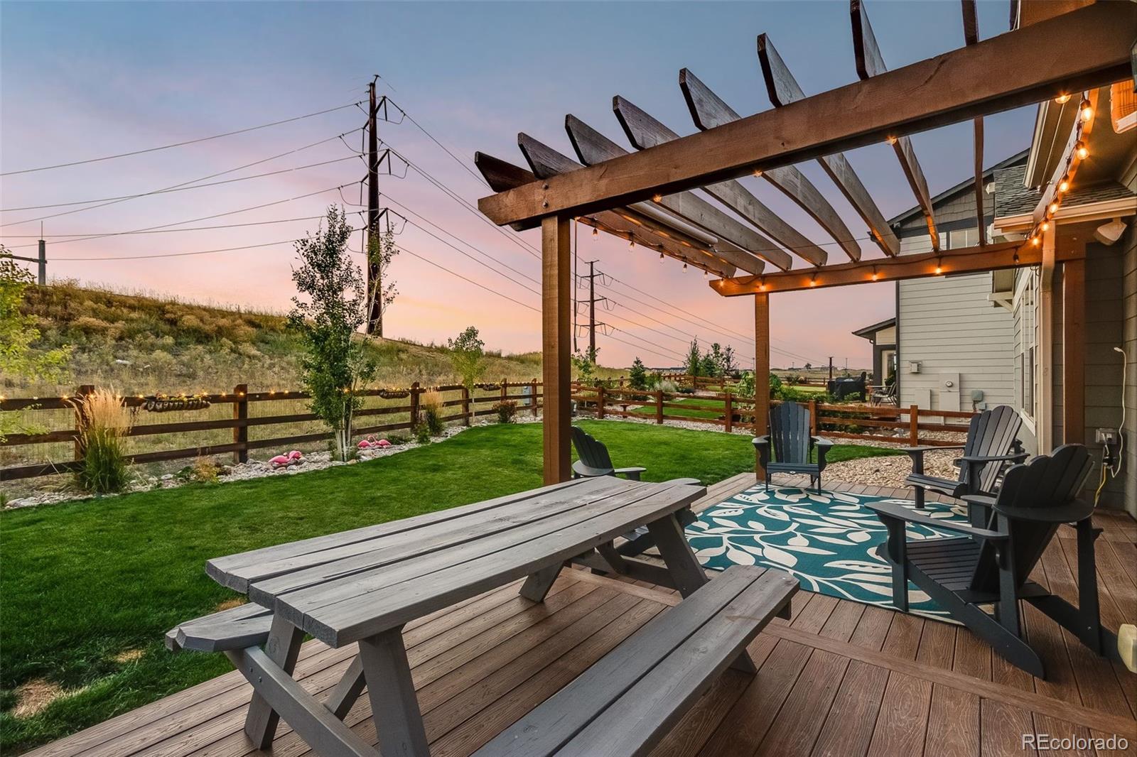 8875 Flattop Way Arvada, CO 80007 - Photo 37 of 38 a view of a deck with wooden floor barbeque grill with a table and chairs