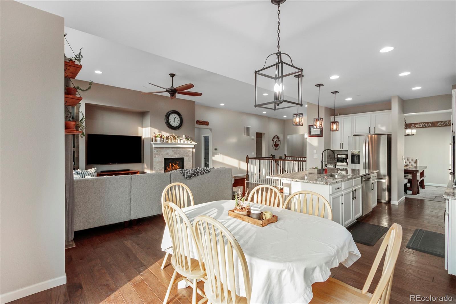 8875 Flattop Way Arvada, CO 80007 - Photo 10 of 38 a view of a dining room with furniture wooden floor and chandelier