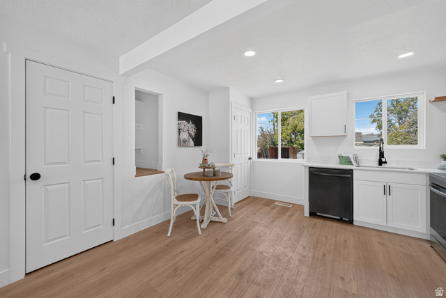 546 West 200 South Payson, UT 84651 - Photo 25 of 45 Kitchen featuring white cabinetry, light countertops, wood-finish flooring, two windows, and recessed lighting