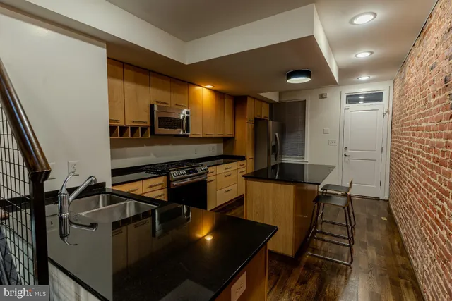 a kitchen with stainless steel appliances granite countertop a stove and a refrigerator