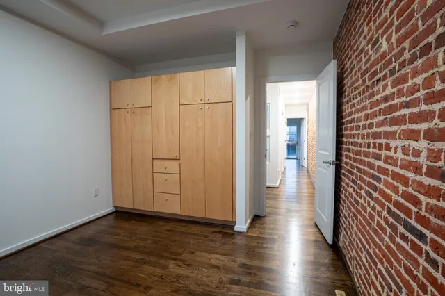 a view of a hallway with wooden floor