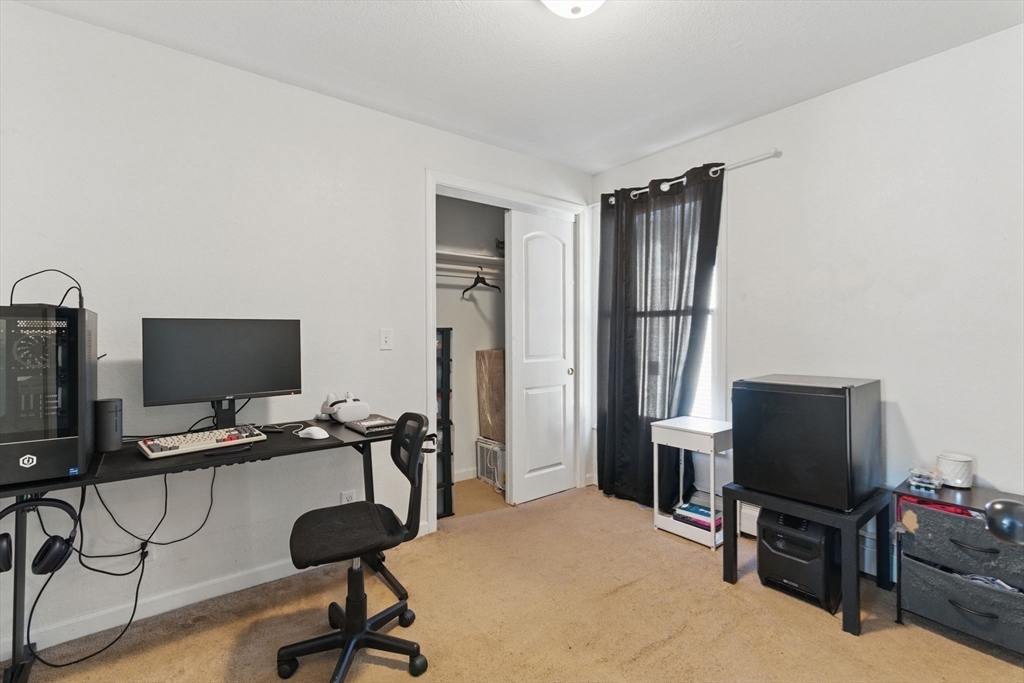 166-168 Corthell Street Springfield, MA 01151 - Photo 12 of 33 a view of a workspace with furniture and a flat screen tv
