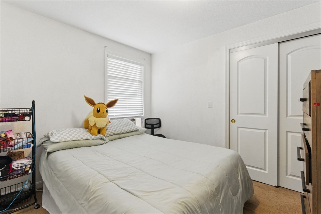 166-168 Corthell Street Springfield, MA 01151 - Photo 13 of 33 a bedroom with a bed and a window