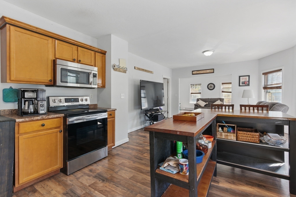 166-168 Corthell Street Springfield, MA 01151 - Photo 23 of 33 a kitchen with stainless steel appliances granite countertop a stove top oven a sink dishwasher and cabinets with wooden floor