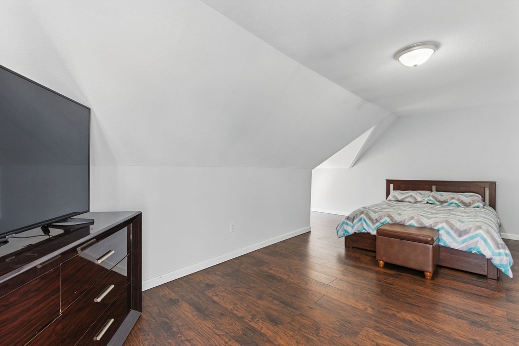 166-168 Corthell Street Springfield, MA 01151 - Photo 26 of 33 a bedroom with a bed and a flat screen tv