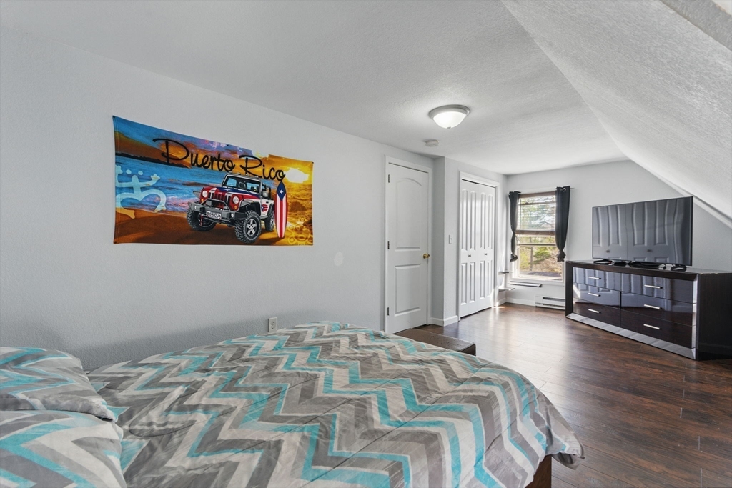 166-168 Corthell Street Springfield, MA 01151 - Photo 27 of 33 a bedroom with a bed and a television in it