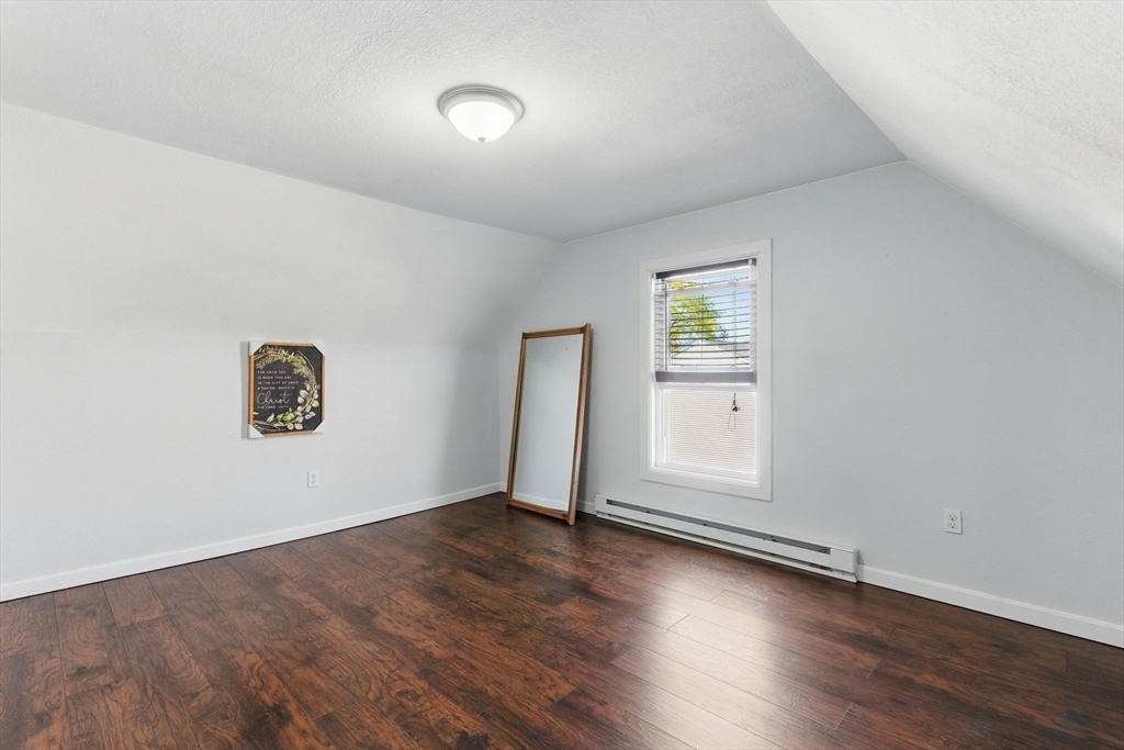166-168 Corthell Street Springfield, MA 01151 - Photo 28 of 33 an empty room with wooden floor and window