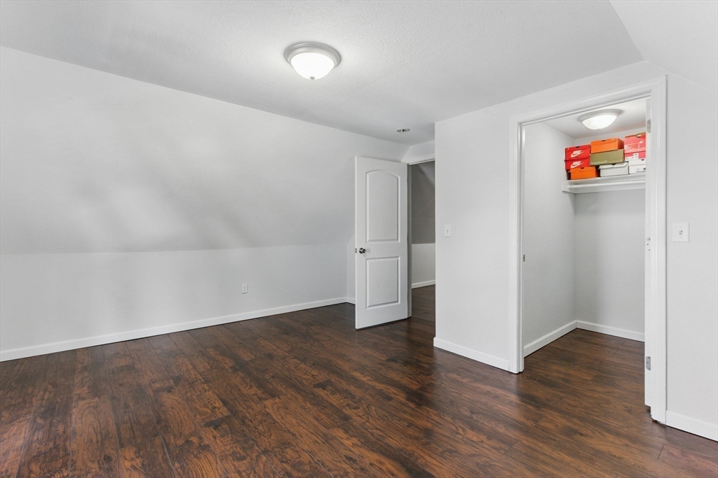 166-168 Corthell Street Springfield, MA 01151 - Photo 29 of 33 an empty room with wooden floor & cabinets