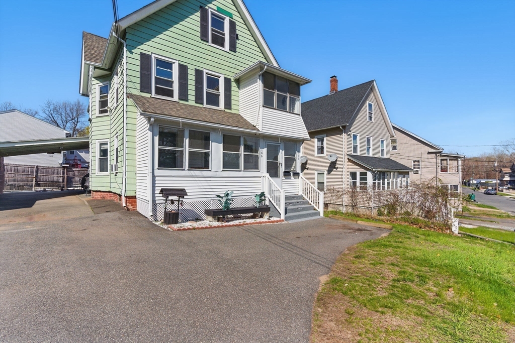166-168 Corthell Street Springfield, MA 01151 - Photo 33 of 33 a front view of a residential apartment building with a yard