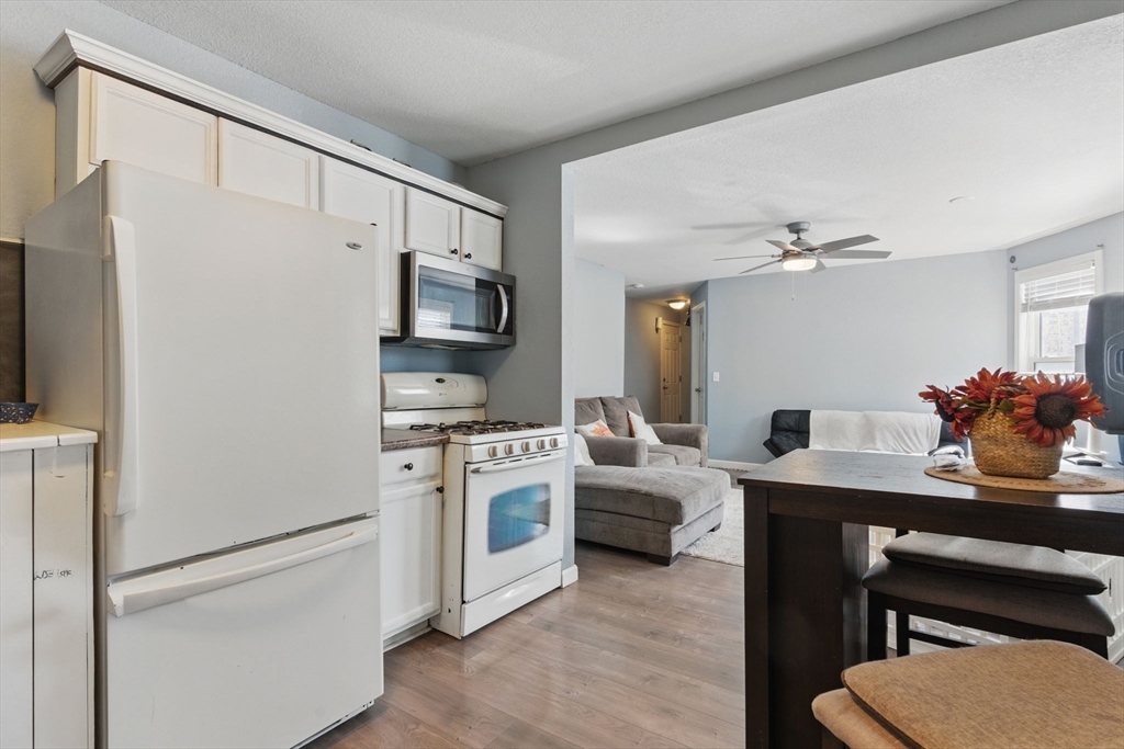 166-168 Corthell Street Springfield, MA 01151 - Photo 7 of 33 a kitchen with stainless steel appliances a stove refrigerator sink and white cabinets
