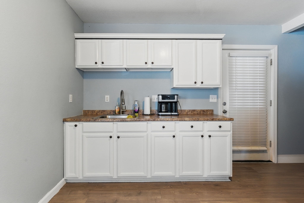 166-168 Corthell Street Springfield, MA 01151 - Photo 8 of 33 a kitchen with granite countertop white cabinets and sink