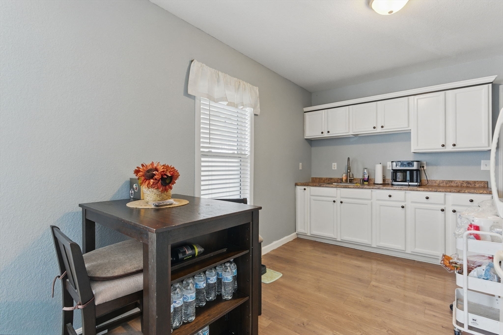 166-168 Corthell Street Springfield, MA 01151 - Photo 9 of 33 a kitchen with a sink cabinets and window