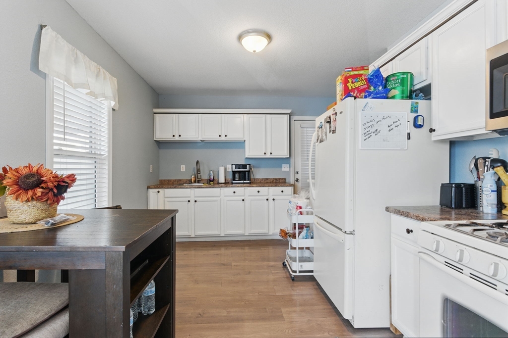 166-168 Corthell Street Springfield, MA 01151 - Photo 10 of 33 a kitchen with white cabinets and refrigerator