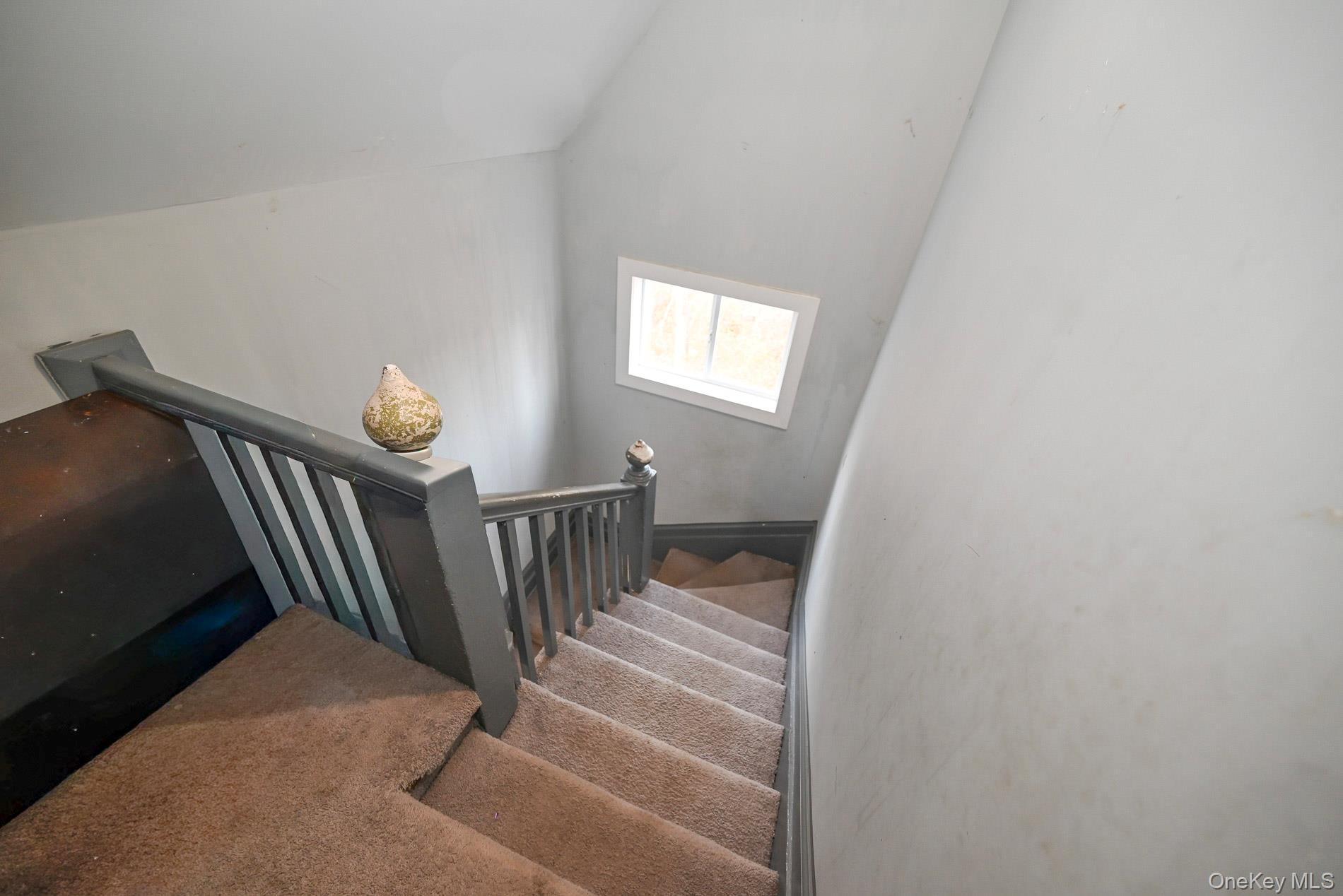 45 Rider Avenue Patchogue, NY 11772 - Photo 12 of 29 a view of staircase with railing and white walls