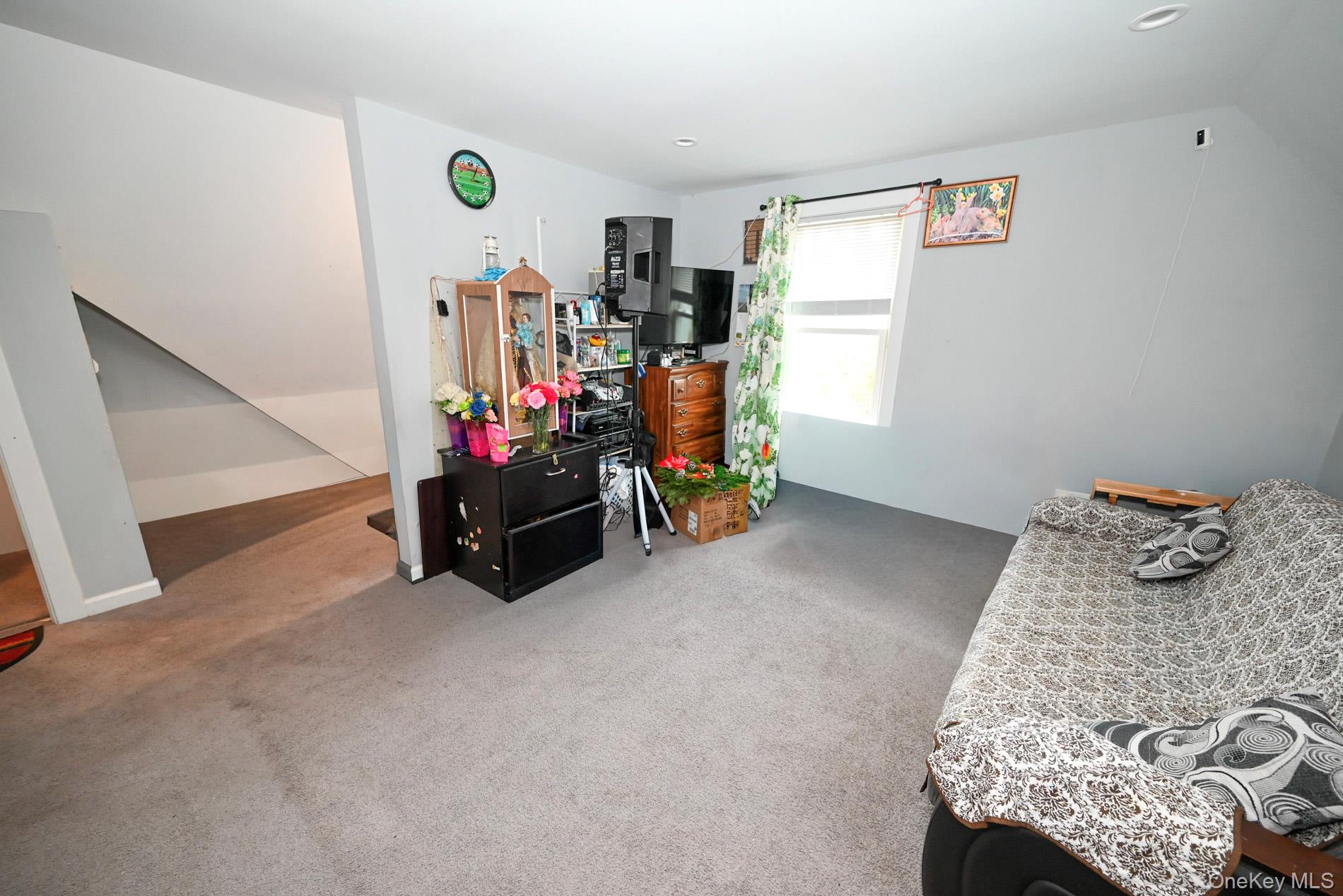 45 Rider Avenue Patchogue, NY 11772 - Photo 16 of 29 a bedroom with furniture and a window