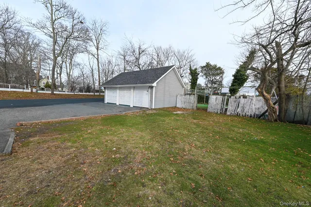 a view of a house with a yard covered with trees