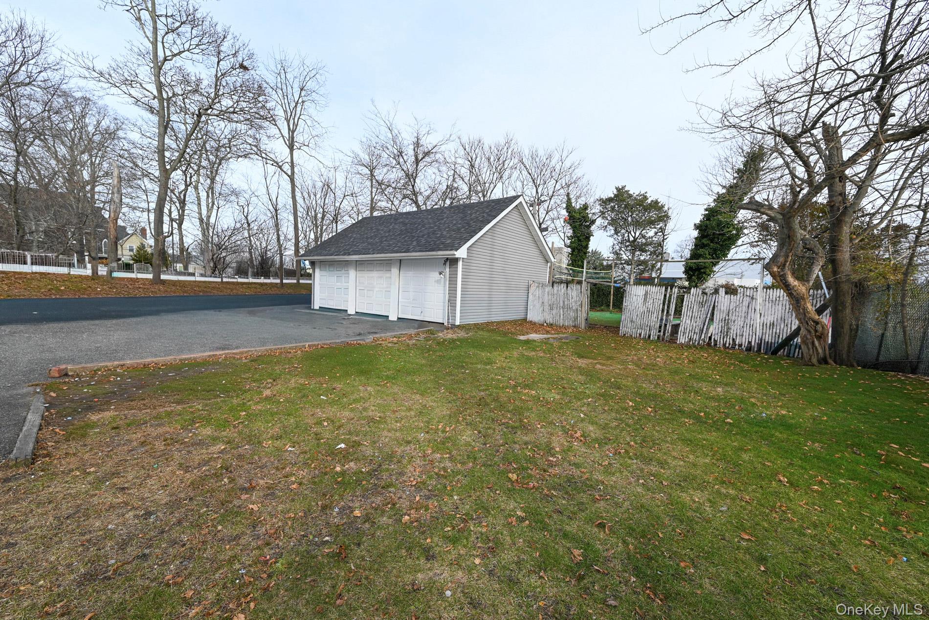 45 Rider Avenue Patchogue, NY 11772 - Photo 2 of 29 a view of a house with a yard covered with trees