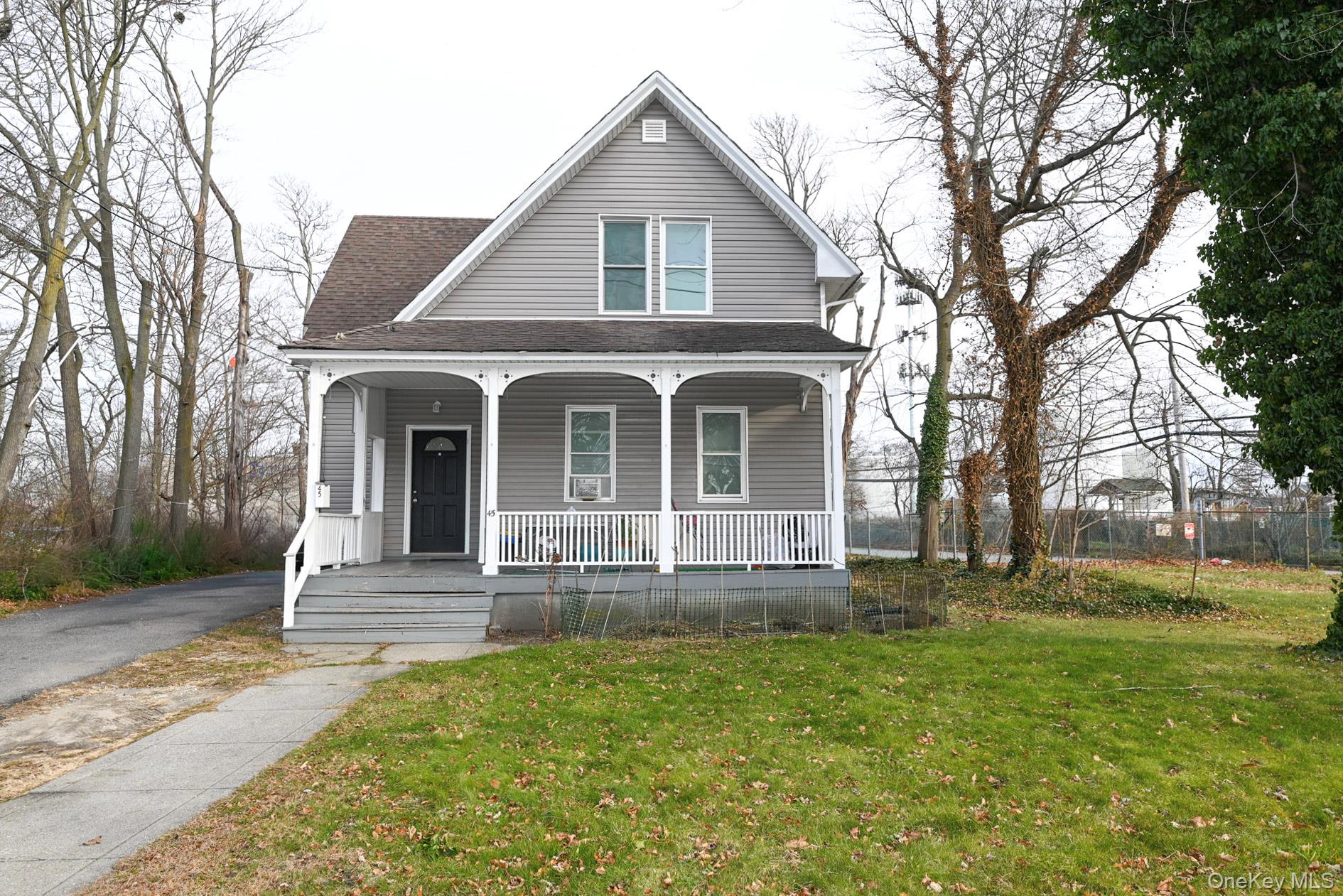 45 Rider Avenue Patchogue, NY 11772 - Photo 28 of 29 a front view of a house with a yard