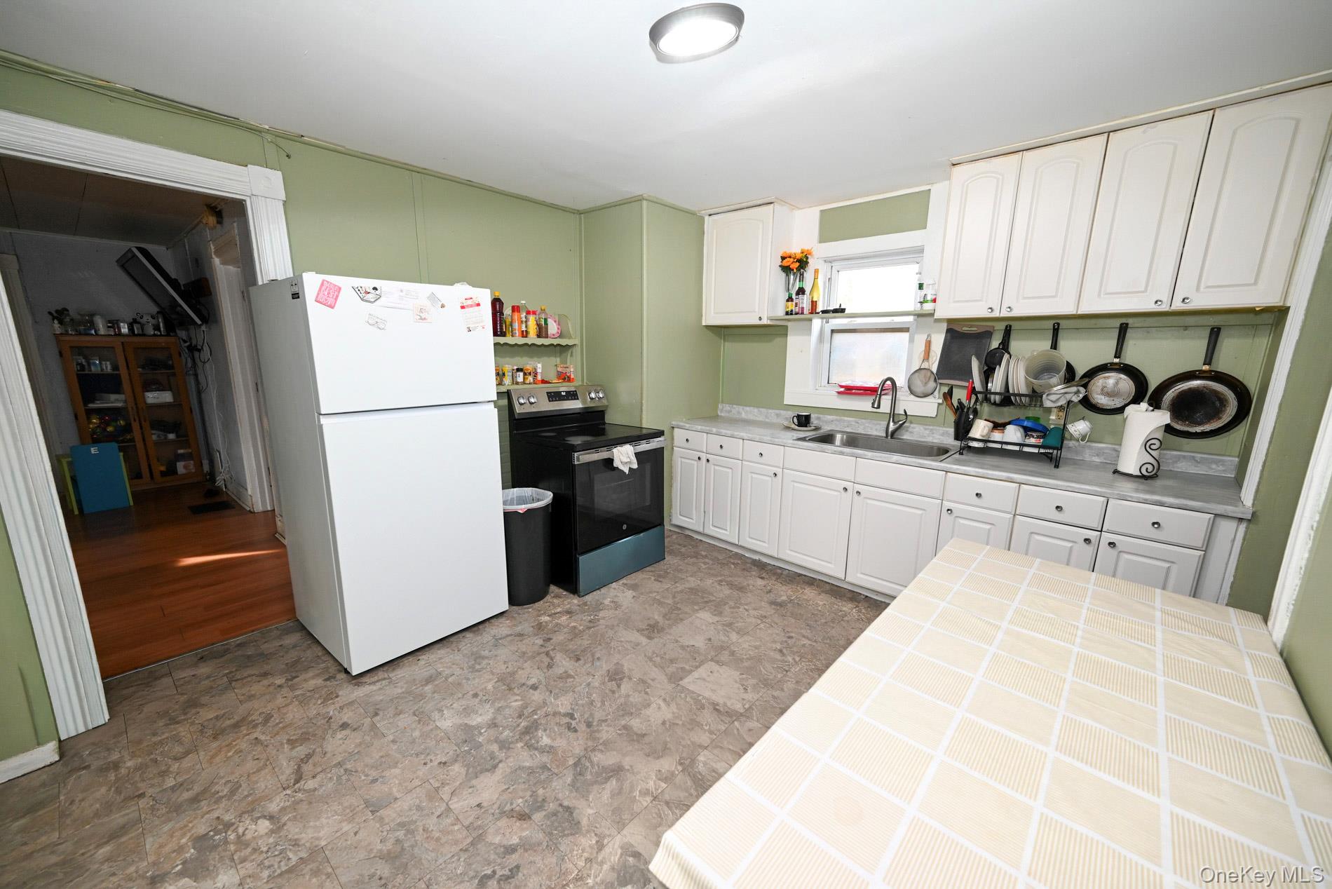 45 Rider Avenue Patchogue, NY 11772 - Photo 3 of 29 a kitchen with a refrigerator and a stove top oven