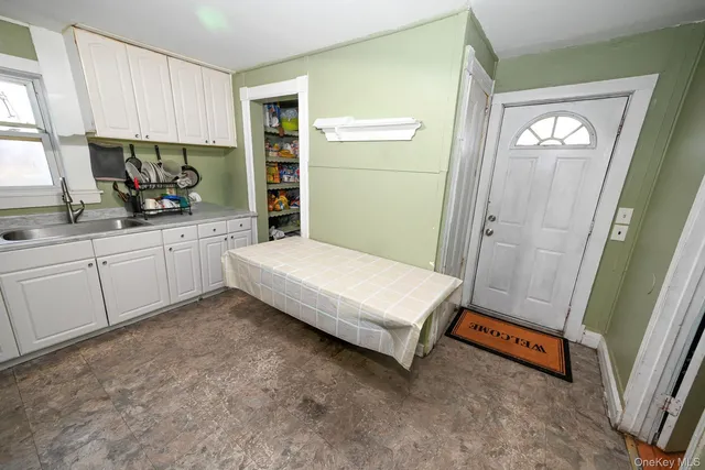 a spacious bedroom with a bed and a window