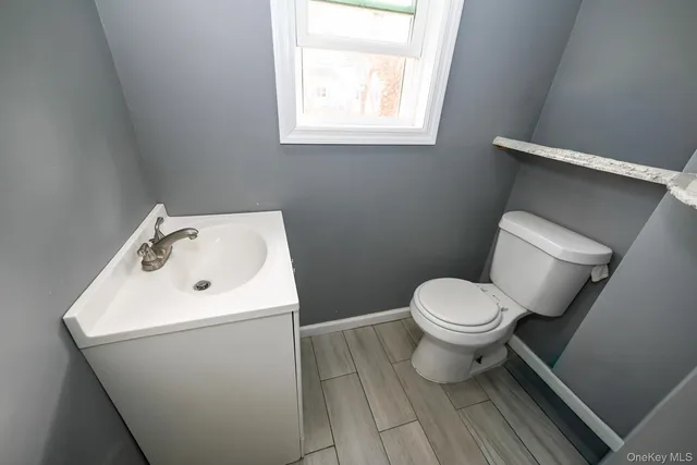 a white toilet sitting next to a bathroom sink