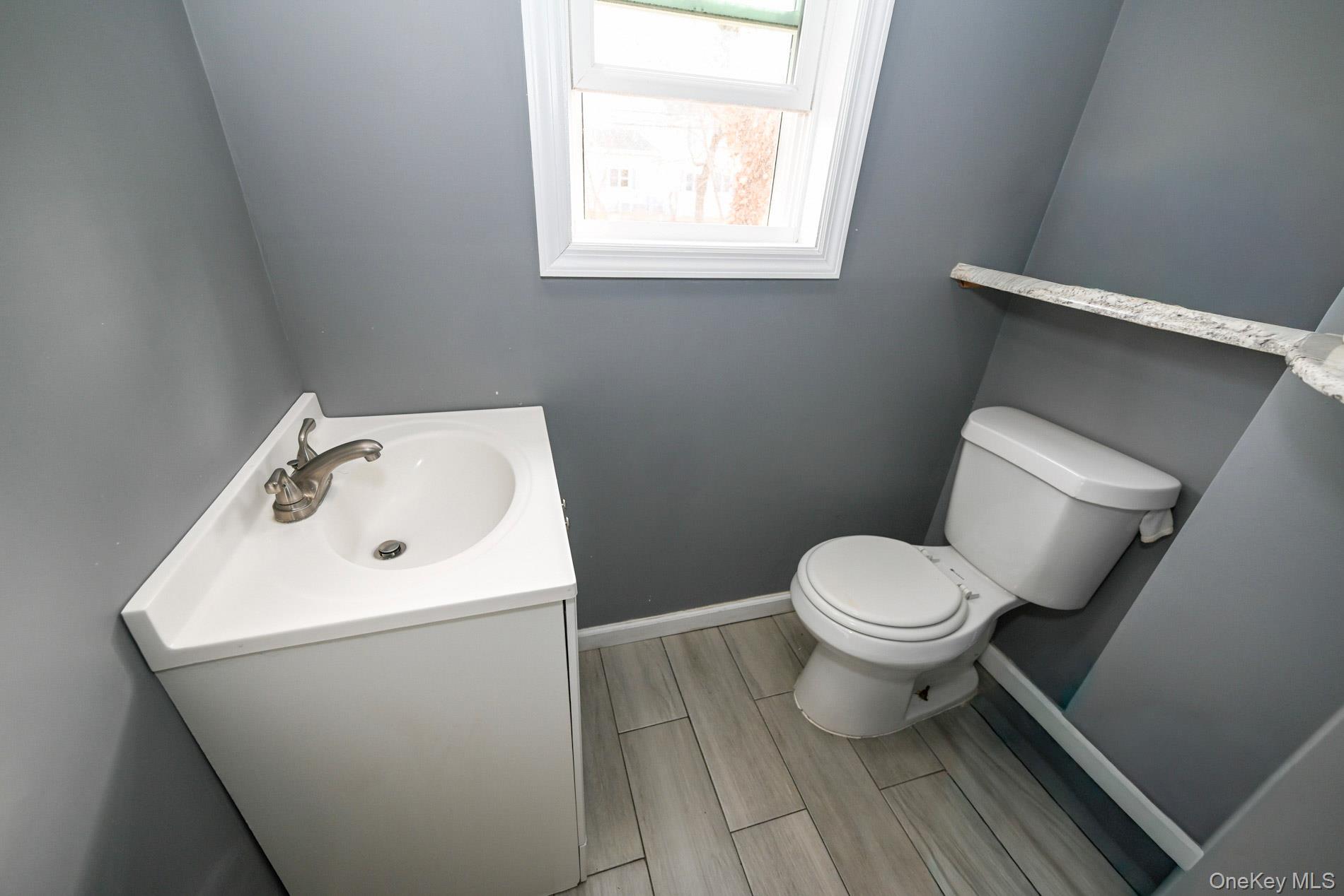 45 Rider Avenue Patchogue, NY 11772 - Photo 6 of 29 a white toilet sitting next to a bathroom sink