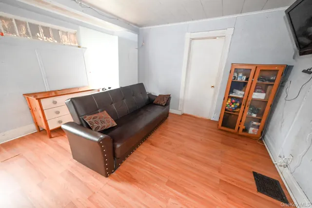 a living room with furniture and a baby crib