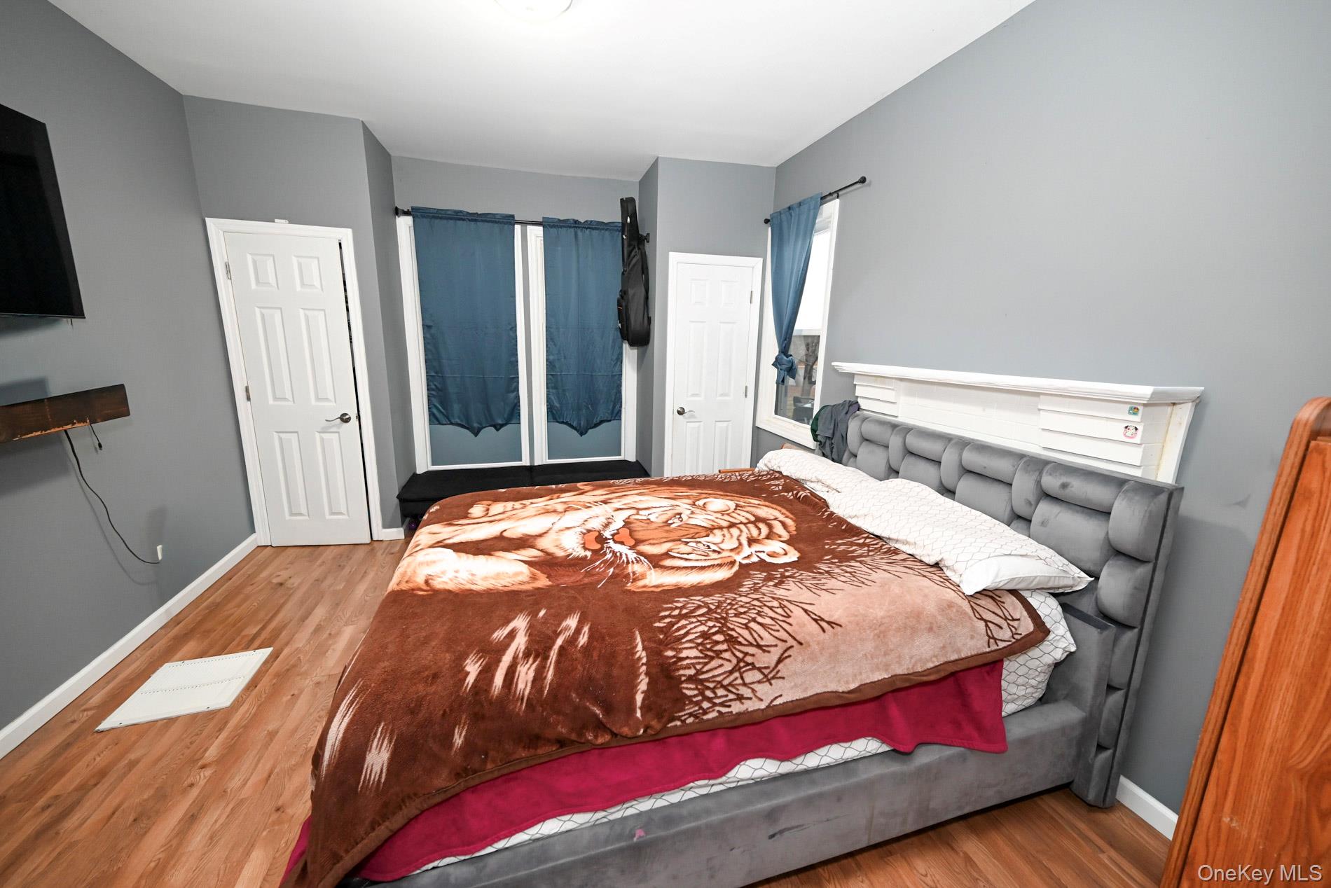 45 Rider Avenue Patchogue, NY 11772 - Photo 10 of 29 a bedroom with a bed and a flat screen tv