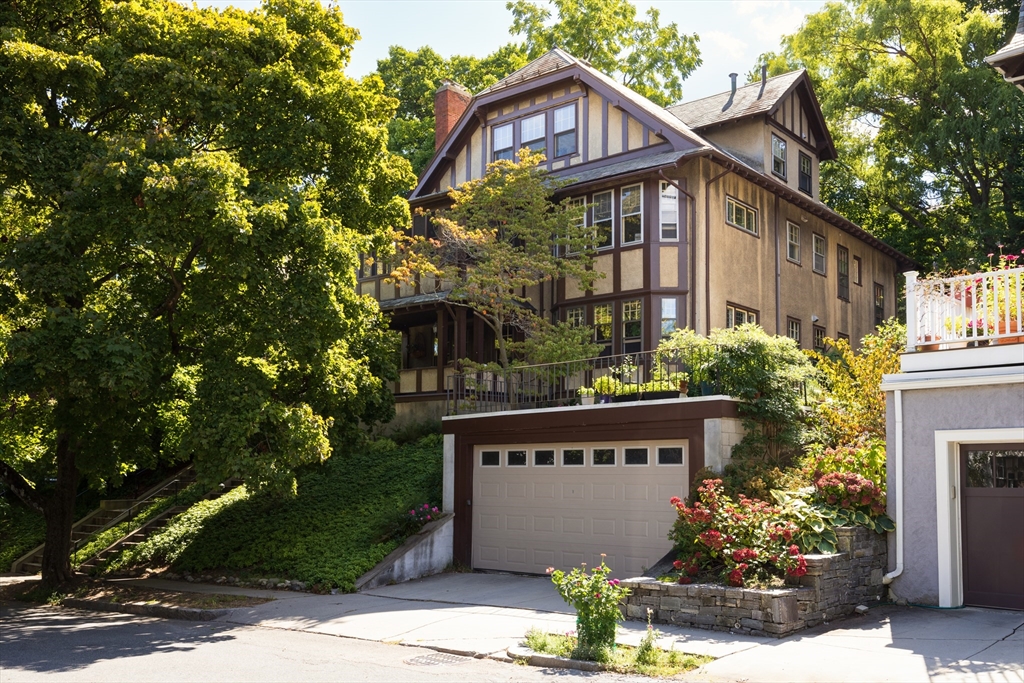 139 University Road, Unit 2 Brookline, MA 02445 - Photo 1 of 16 a front view of a house with a garden