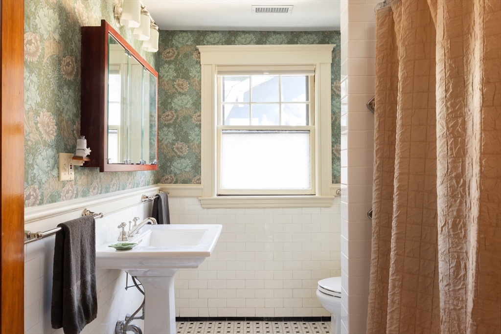 139 University Road, Unit 2 Brookline, MA 02445 - Photo 14 of 16 a bathroom with a sink and a mirror