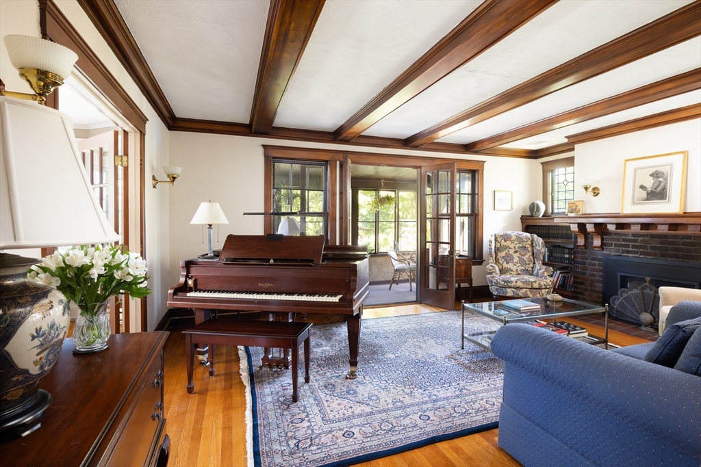 139 University Road, Unit 2 Brookline, MA 02445 - Photo 2 of 16 a living room with furniture fireplace and a large window