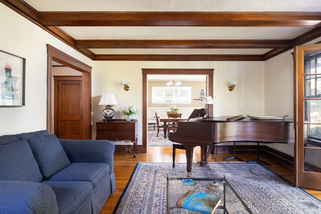 139 University Road, Unit 2 Brookline, MA 02445 - Photo 3 of 16 a living room with furniture a table and a potted plant