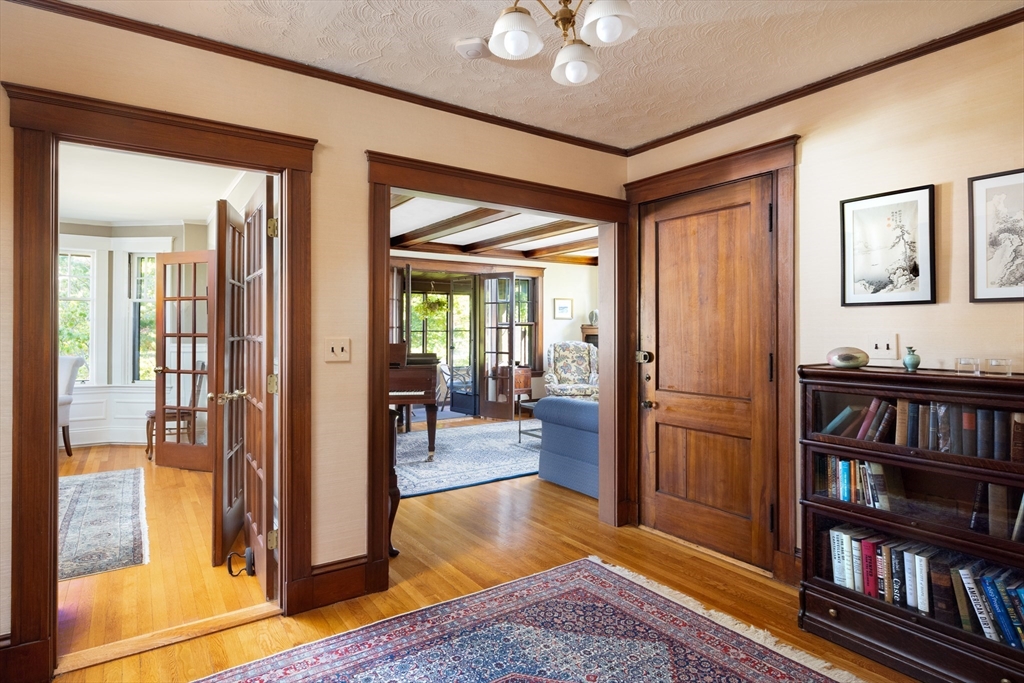 139 University Road, Unit 2 Brookline, MA 02445 - Photo 4 of 16 a view of a livingroom with furniture and a bookshelf