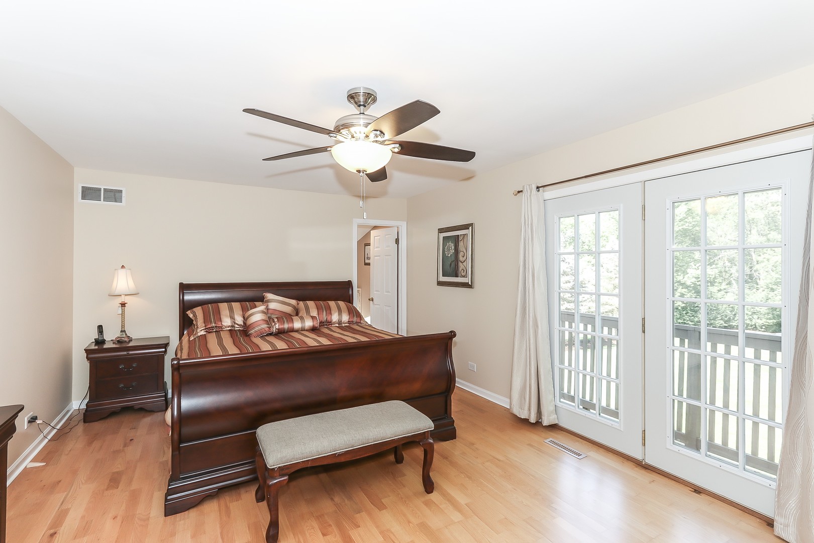 207 Ela Road Inverness, IL 60067 - Photo 16 of 30 a bedroom with a bed and a chandelier