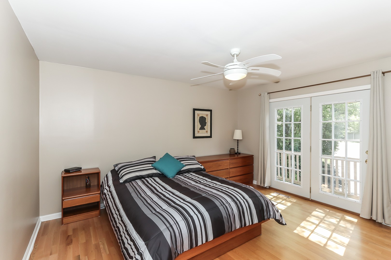 207 Ela Road Inverness, IL 60067 - Photo 22 of 30 a bedroom with a bed and wooden floor
