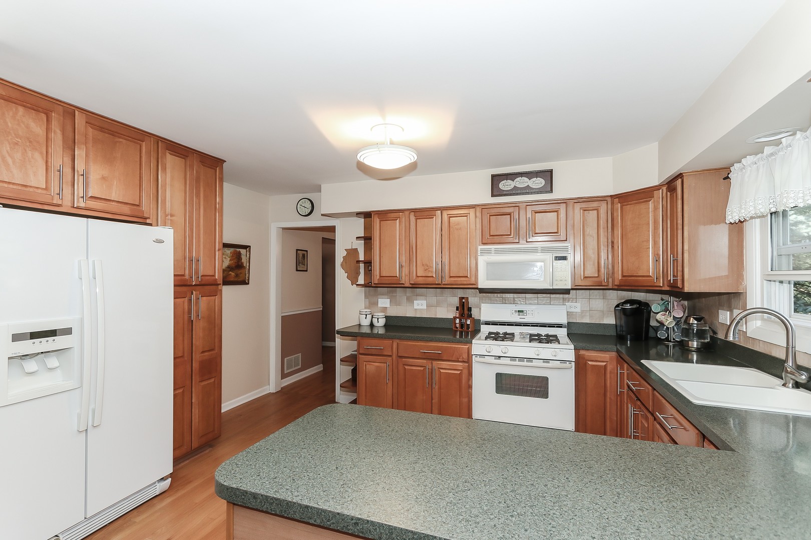 207 Ela Road Inverness, IL 60067 - Photo 7 of 30 a kitchen with stainless steel appliances granite countertop a refrigerator sink and stove
