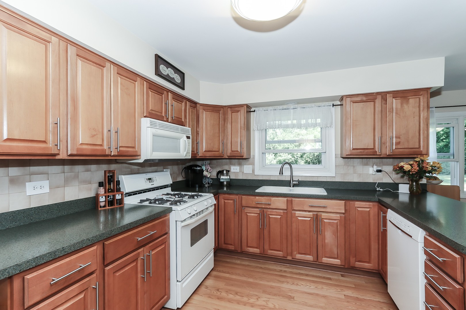 207 Ela Road Inverness, IL 60067 - Photo 8 of 30 a kitchen with stainless steel appliances granite countertop a sink a stove a counter space and cabinets