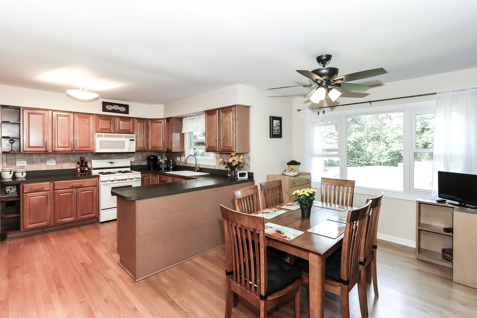 207 Ela Road Inverness, IL 60067 - Photo 10 of 30 a kitchen with stainless steel appliances a table and chairs in it