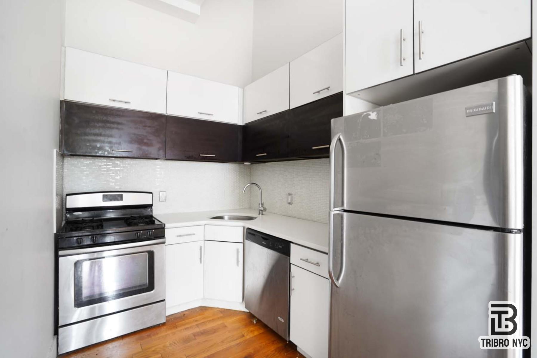 506 Warren Street, Unit 2F Brooklyn, NY 11217 - Photo 2 of 7 a kitchen with a refrigerator and a stove
