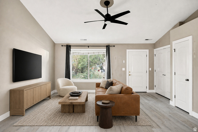 778 South 650 West Logan, UT 84321 - Photo 5 of 26 Staged Open living space featuring light-toned walls, wood-finish flooring, a contemporary ceiling fan, and multiple white panel doors