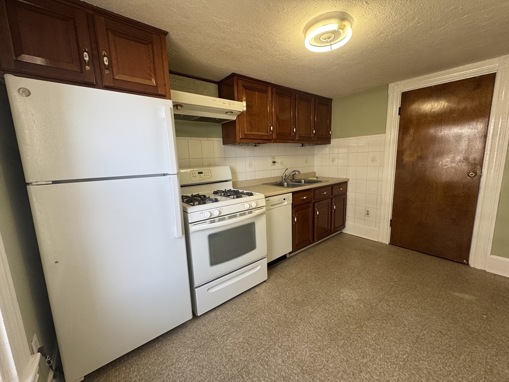 58 Hichborn Street, Unit 2 Boston, MA 02134 - Photo 4 of 15 a white refrigerator freezer and a stove sitting inside of a kitchen