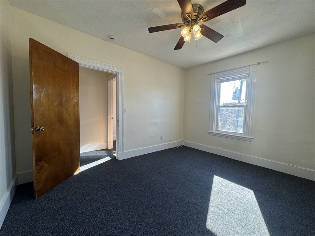 58 Hichborn Street, Unit 2 Boston, MA 02134 - Photo 7 of 15 an empty room with closet and a chandelier fan