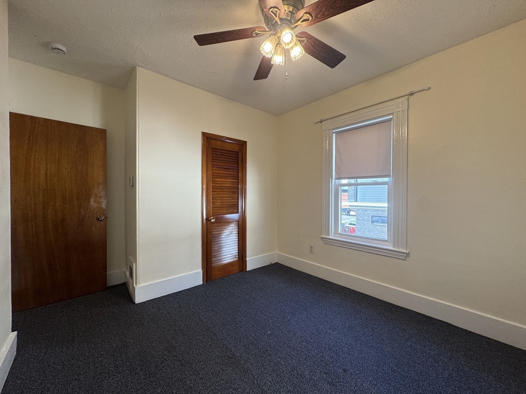 58 Hichborn Street, Unit 2 Boston, MA 02134 - Photo 9 of 15 a view of a livingroom with a ceiling fan and window