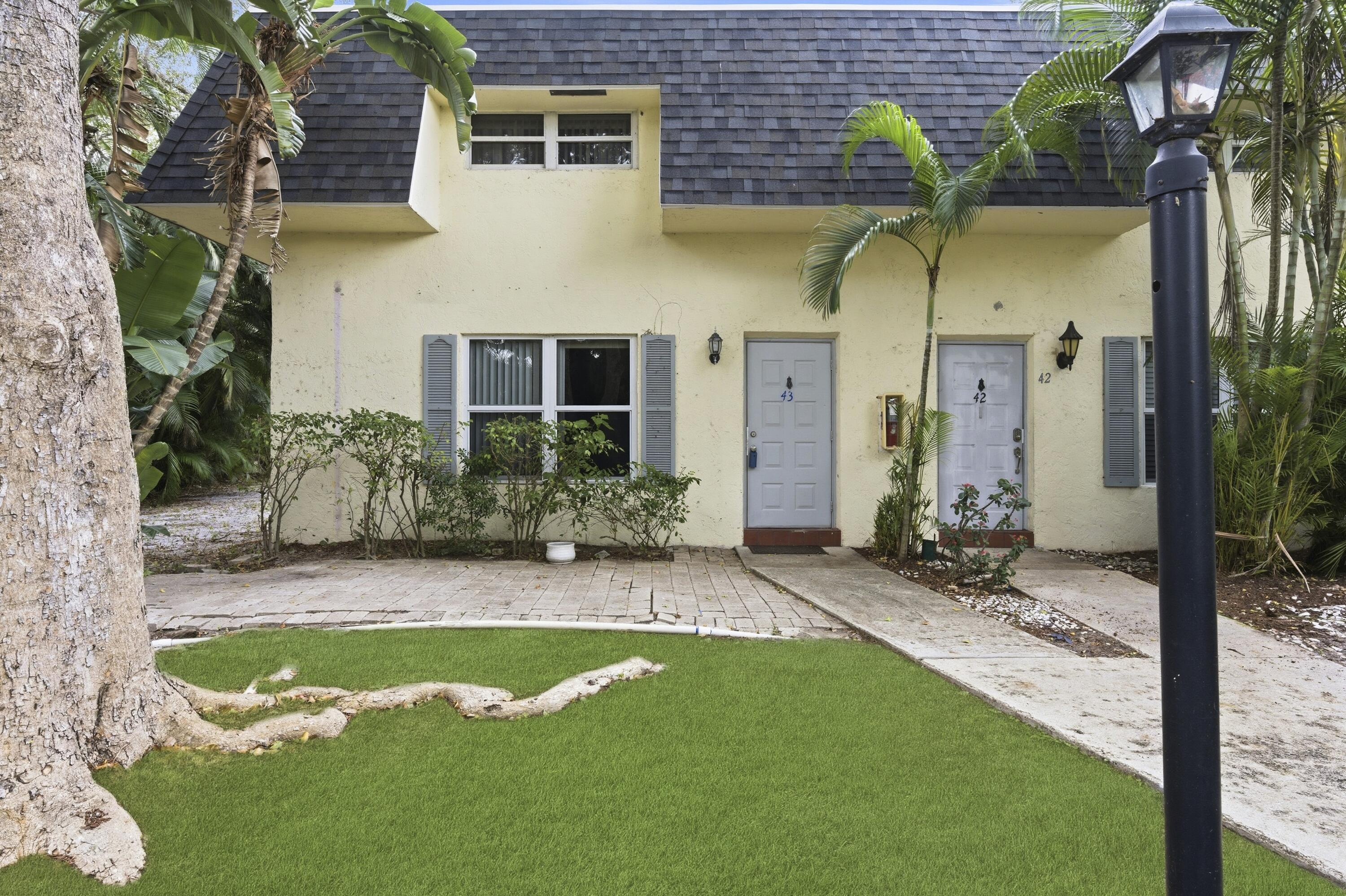1945 Northwest 4th Avenue, Unit 43C Boca Raton, FL 33432 - Photo 1 of 23 a view of a back yard of the house